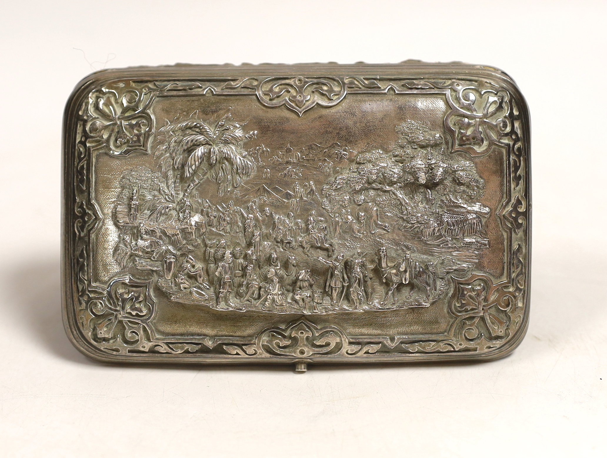 An Indian? white metal cigar case, decorated with figures at various pursuits in relief, 13.5cm, gross weight 309 grams.